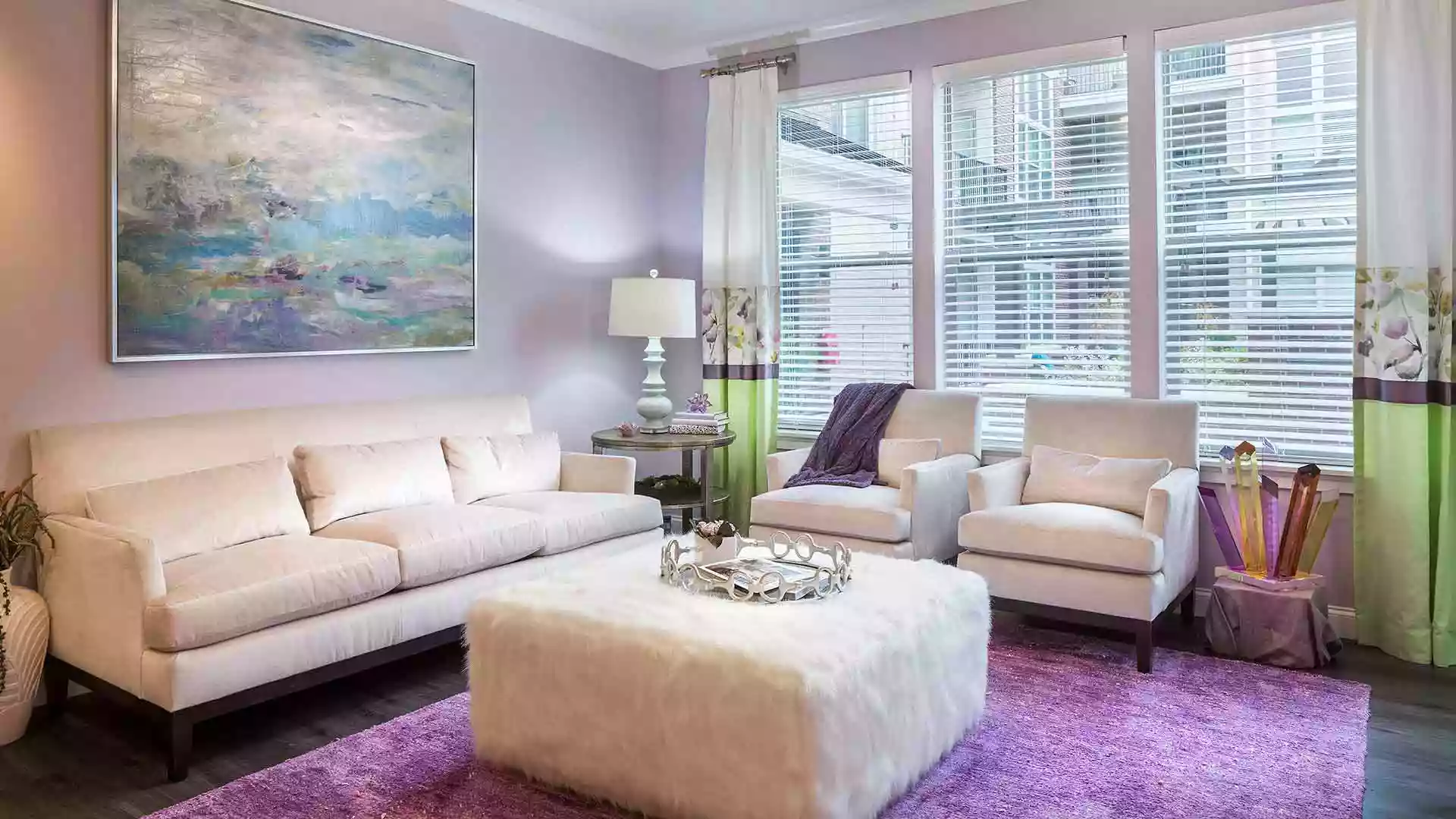 Decorated living room space with large windows at 49Hundred.