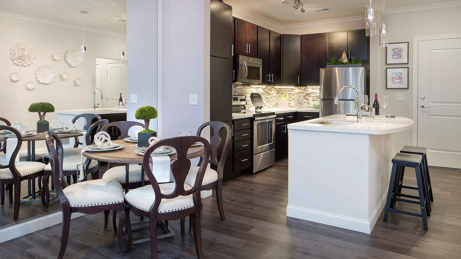Decorated open concept kitchen and dining area at 49Hundred.