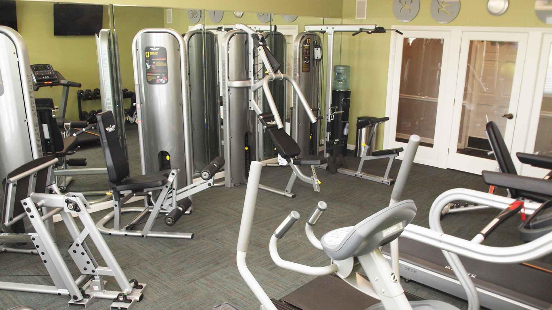 Community fitness center with exercise machines at Emerald Lakes.
