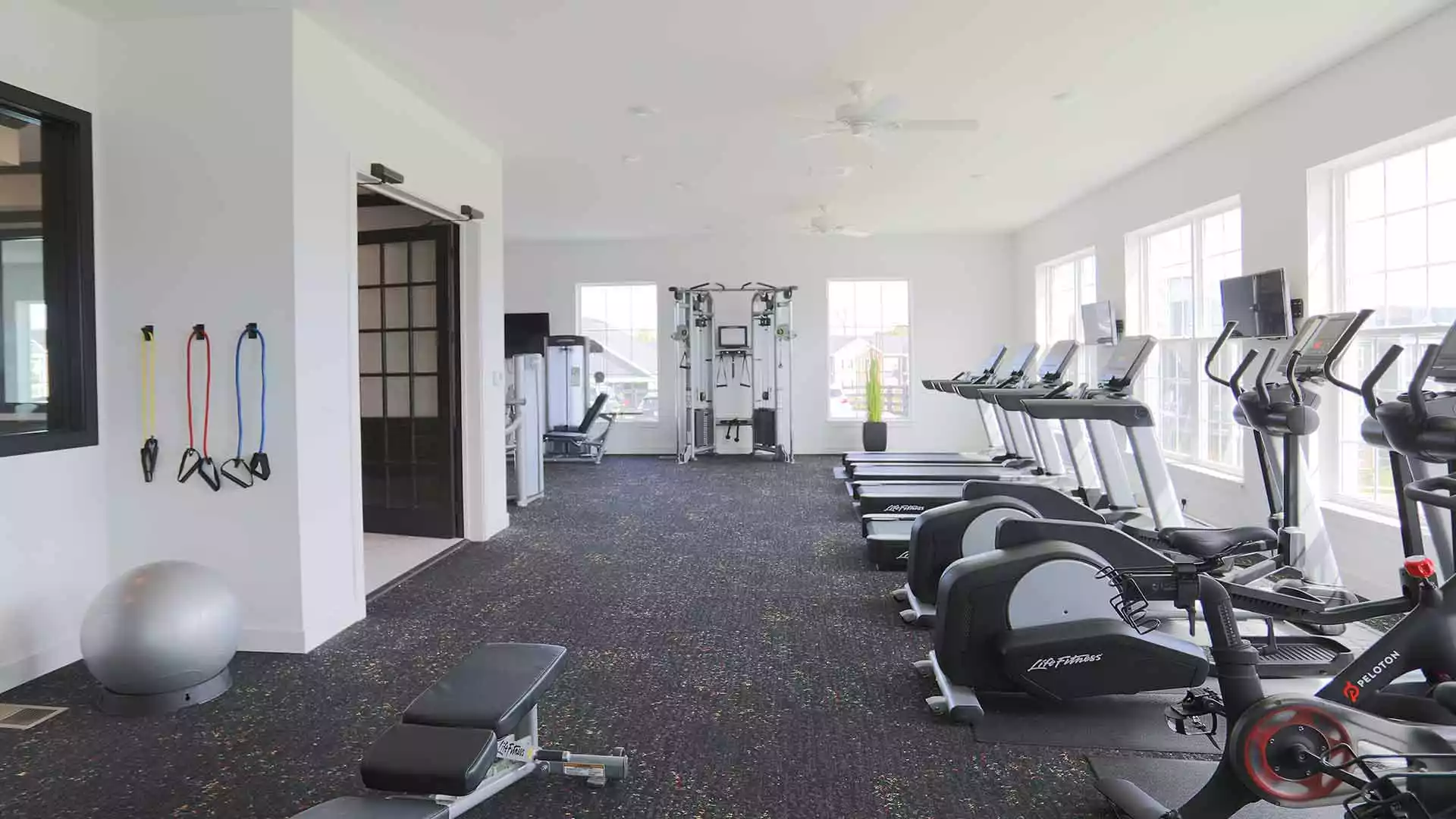 Spacious fitness center with exercise machines at Greyson on 27.
