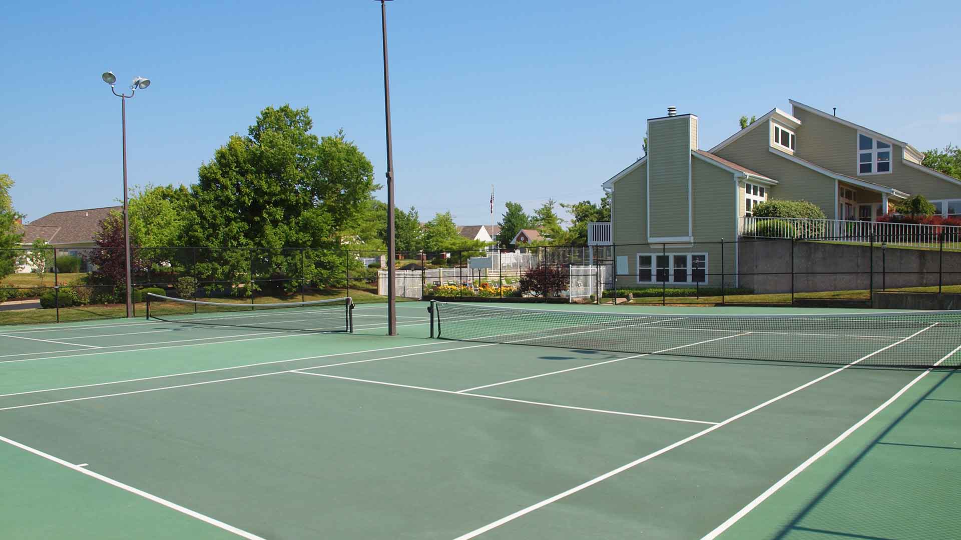 Two fenced in tennis courts at Island Club.