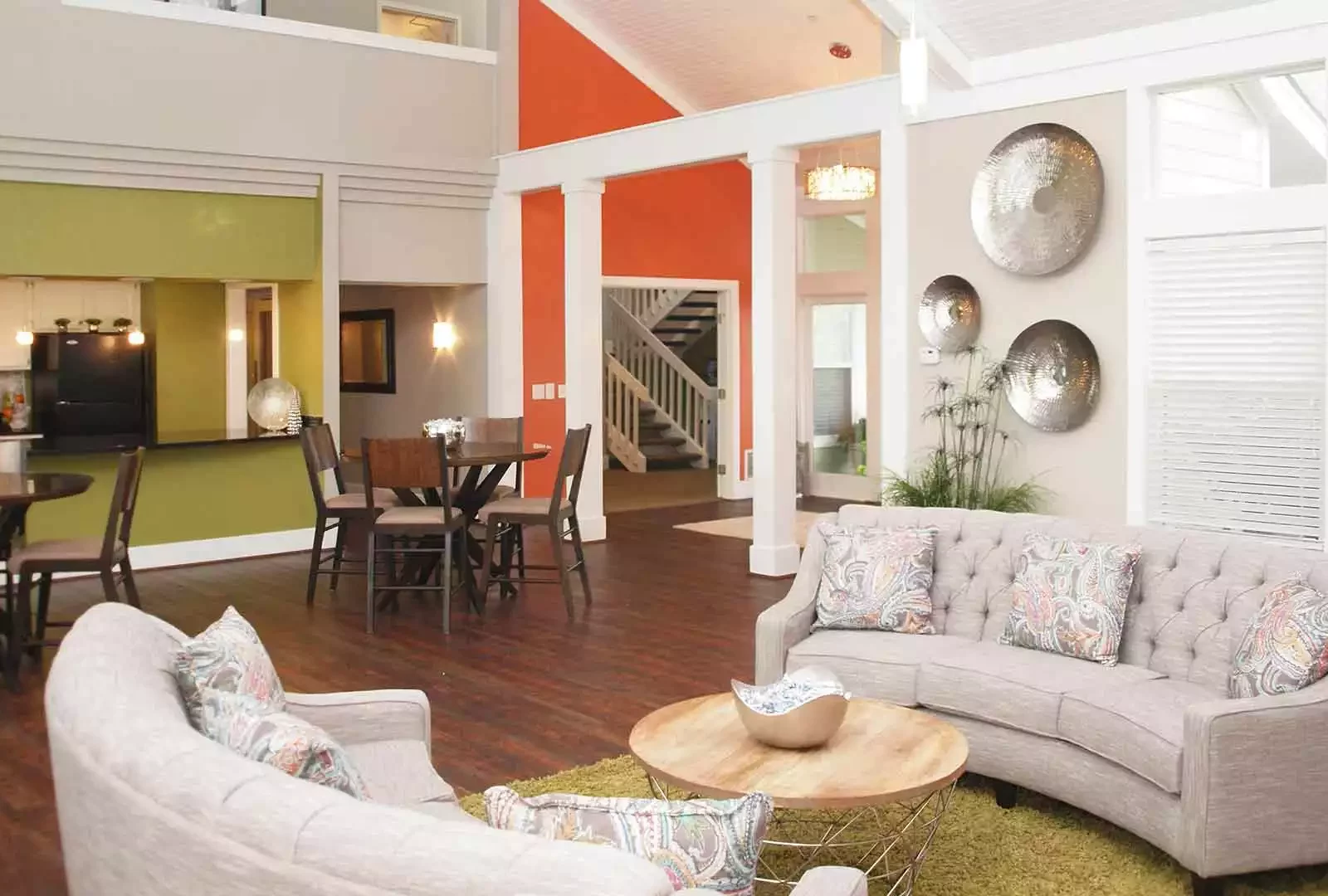 Clubhouse with two kitchen tables and sofas at Island Club Apartments.