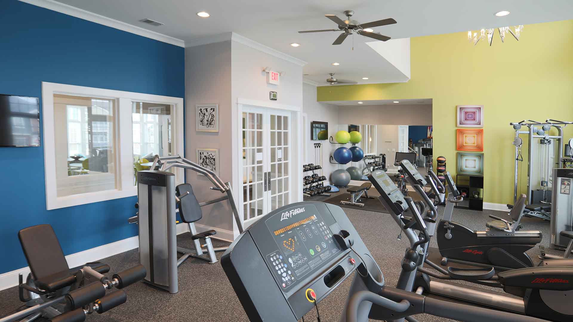 Spacious fitness center with exercise machines and free-weights.