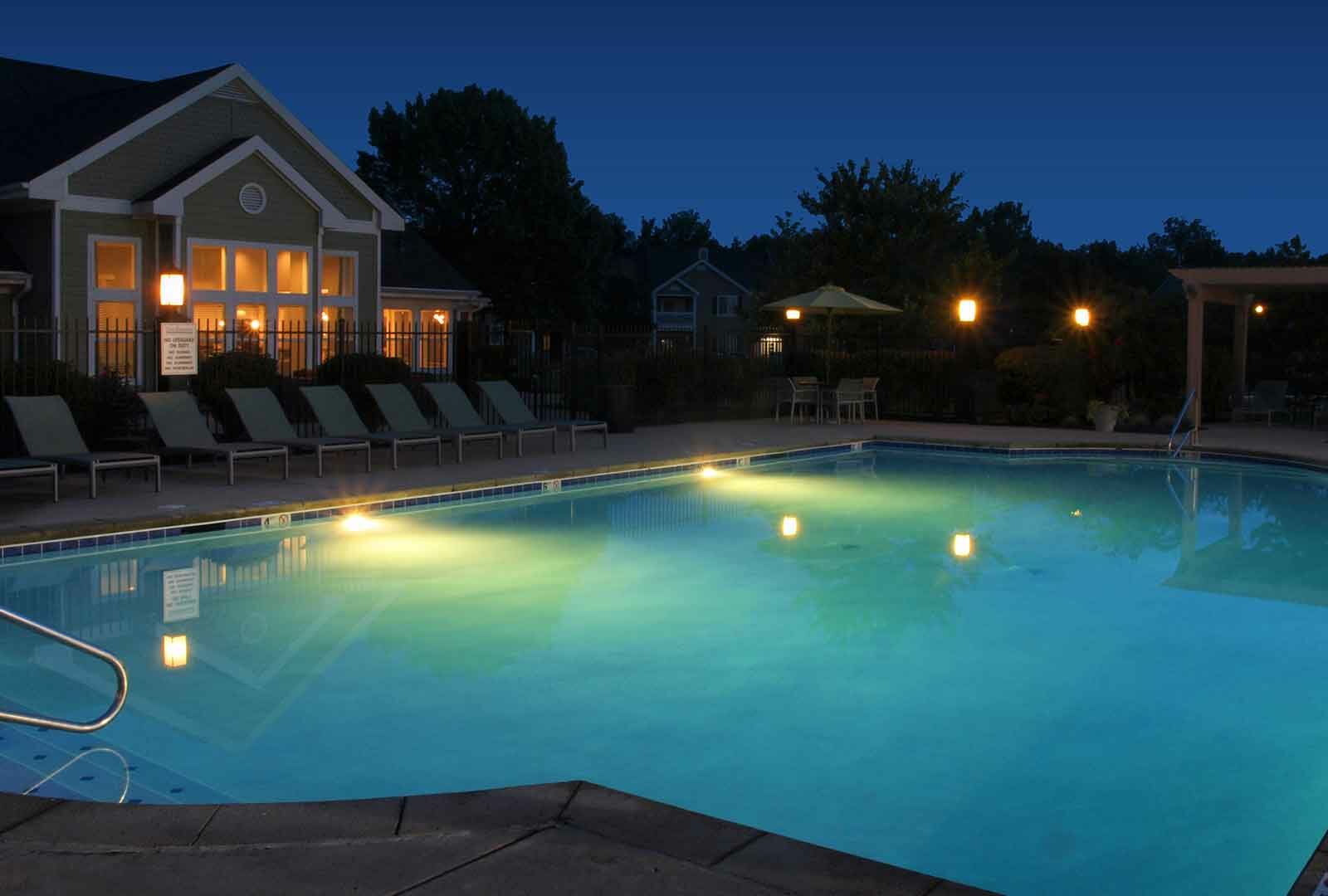 Swimming pool lit at night at Reserve at Miller Farm.