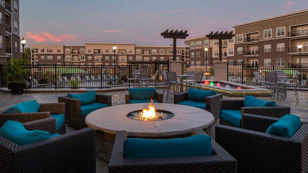 Outdoor fire pit with lounge chairs on terrace at Savoy of West Chester.