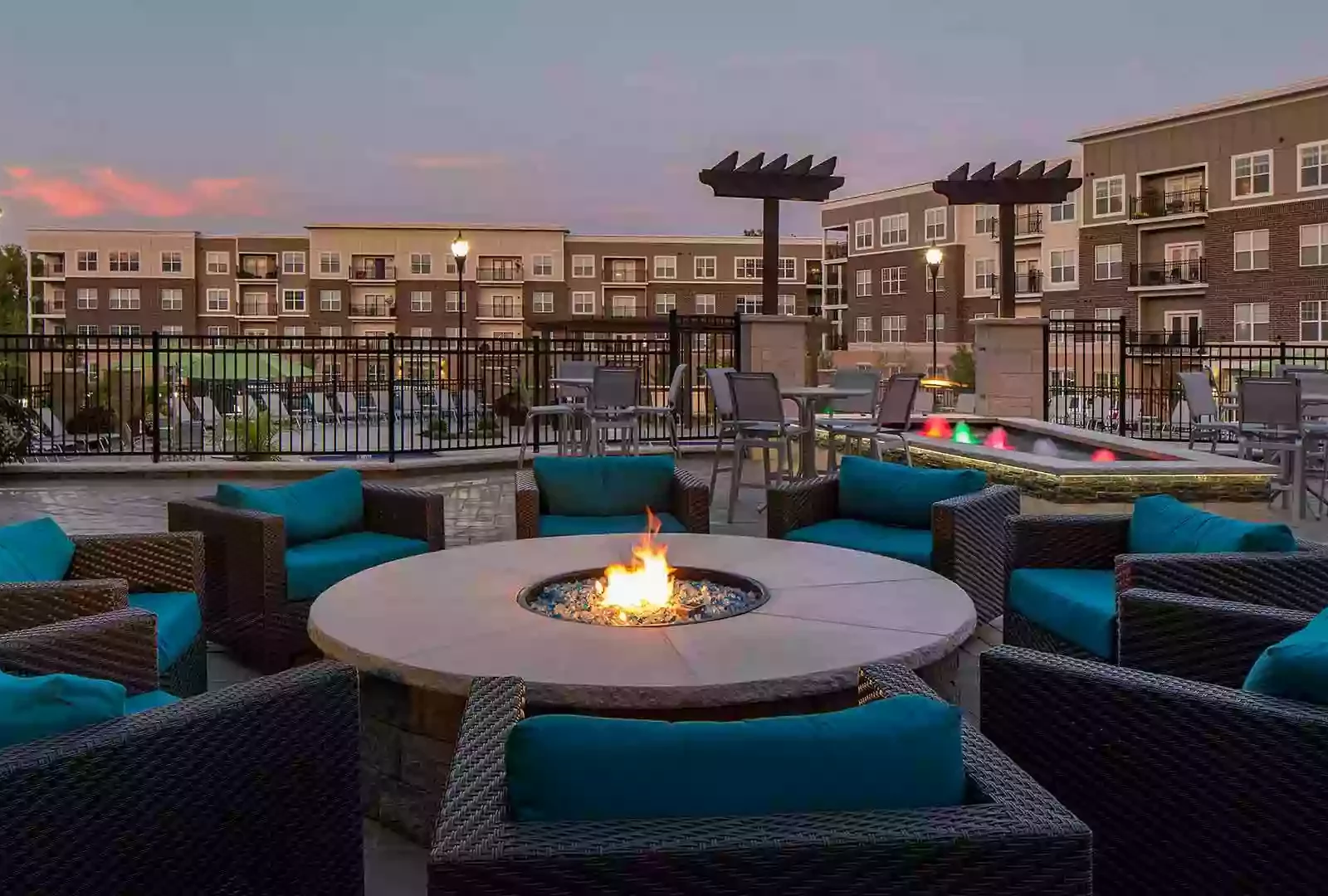 Outdoor fire pit with lounge chairs on terrace at Savoy of West Chester.