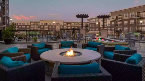 Outdoor fire pit with lounge chairs on terrace at Savoy of West Chester.