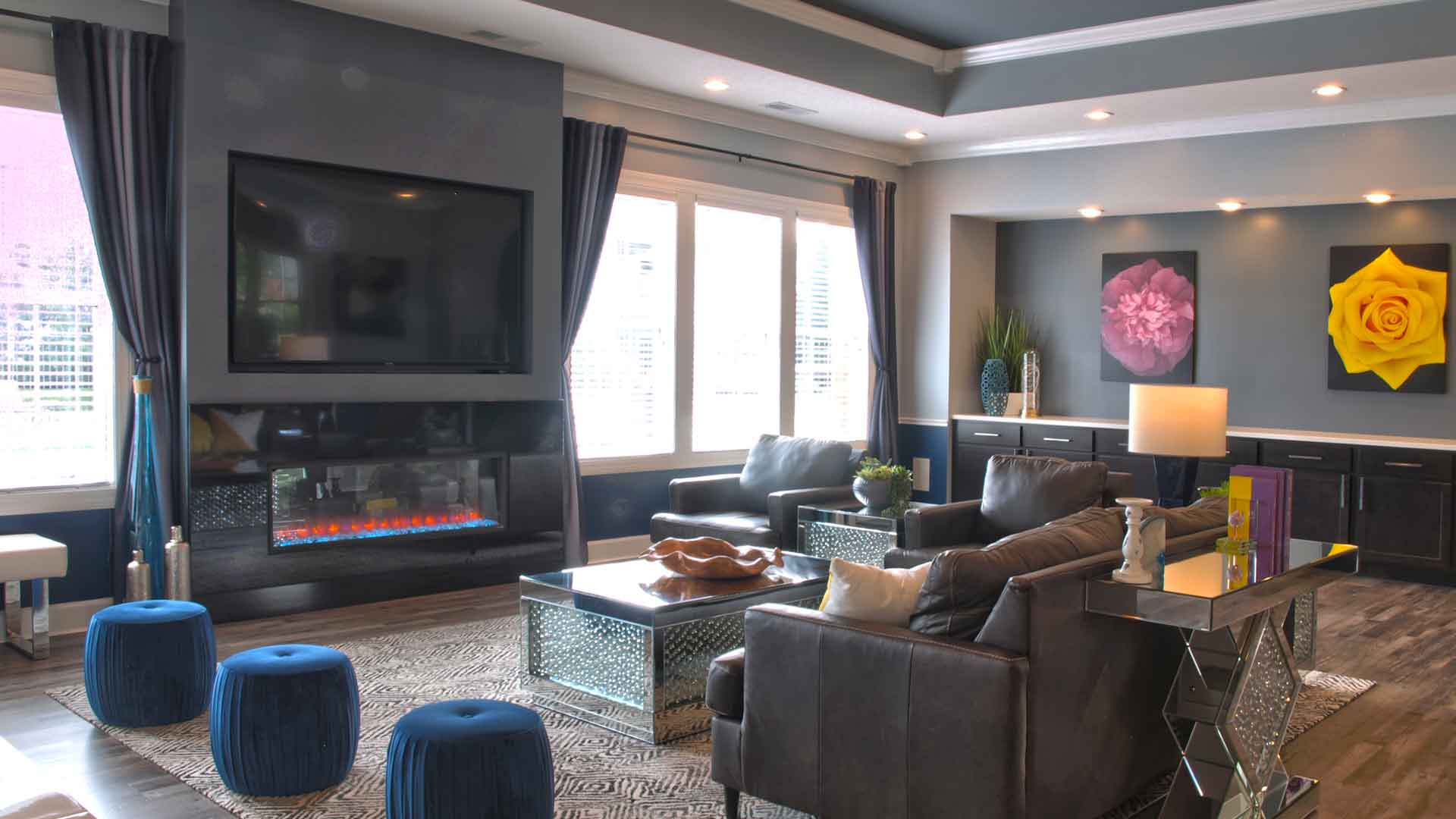 Furnished and decorated clubhouse with electric fireplace and flat screen TV.