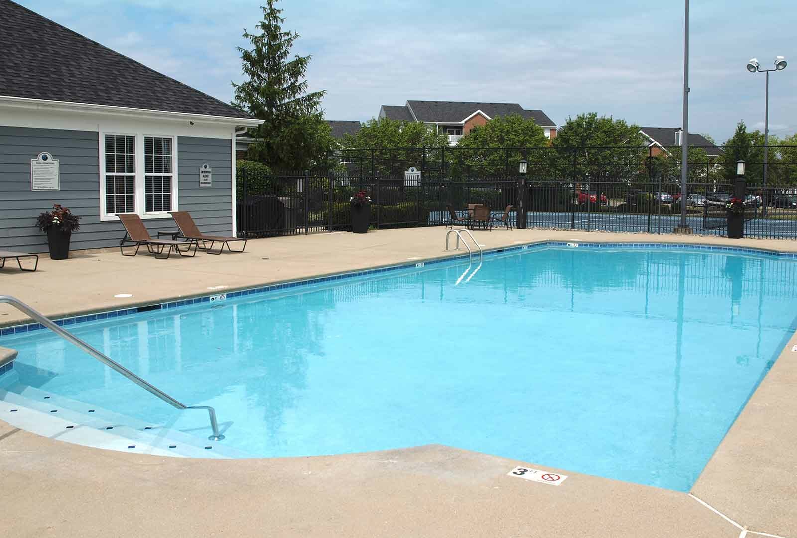 Outdoor pool and lounge deck at Sterling Lakes.