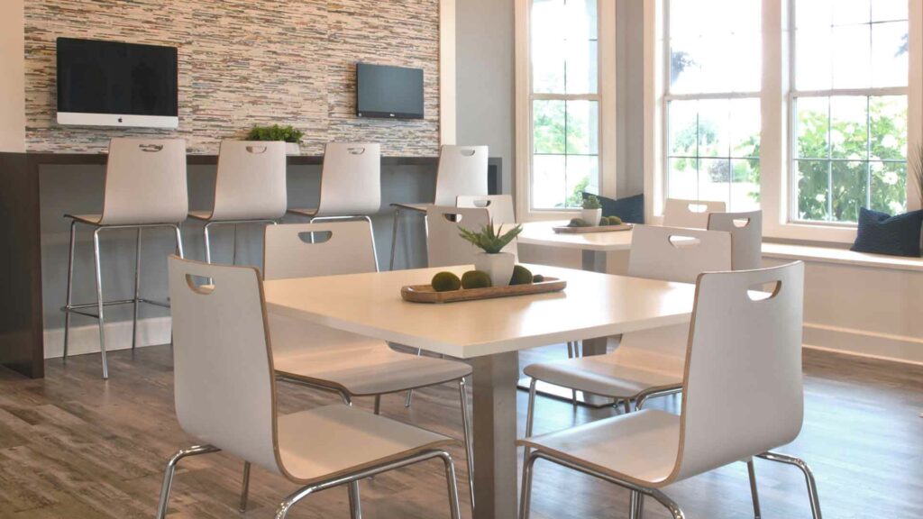 Tables and chairs in an office space for apartment residents.