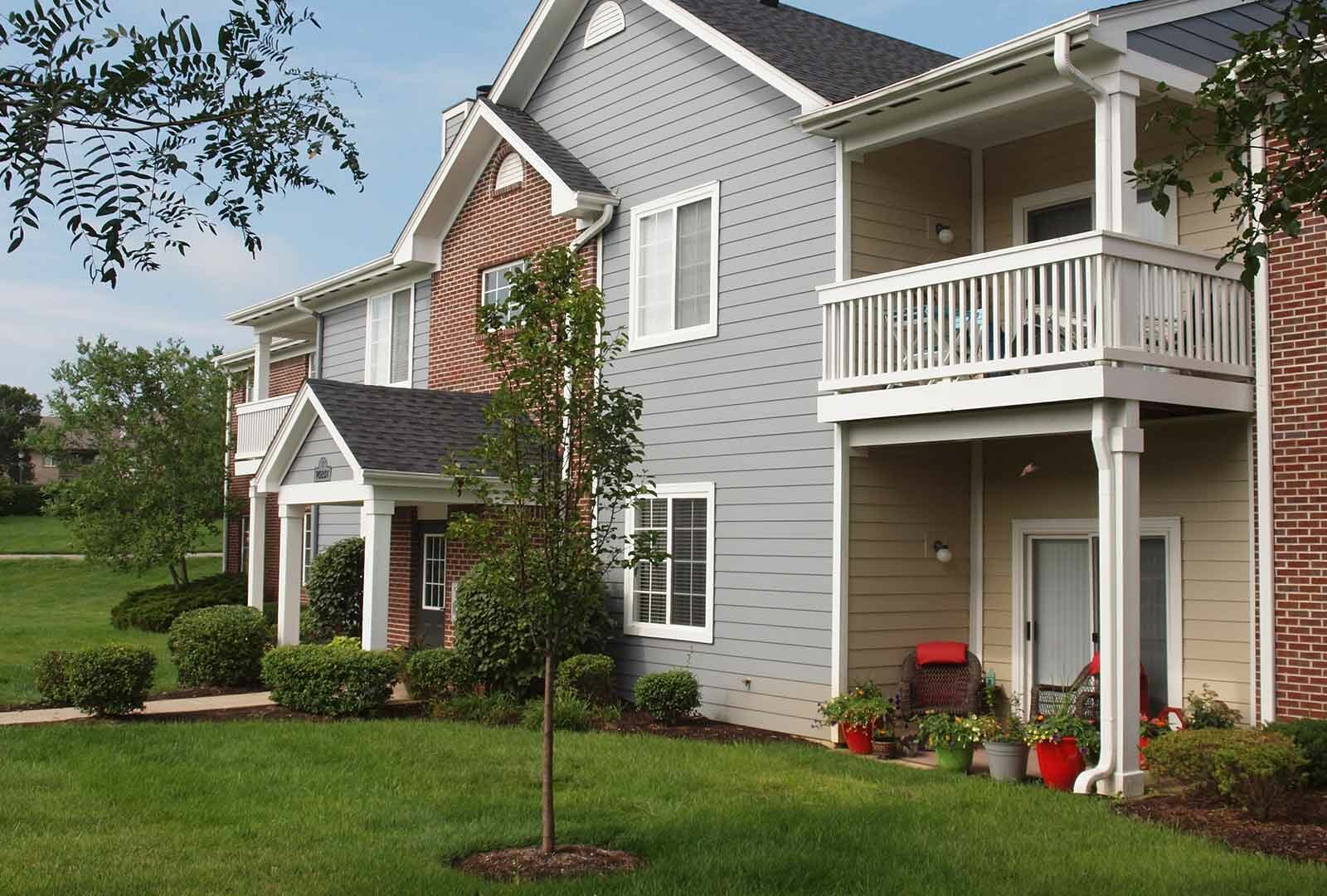 Apartment building exterior with balconies and landscaping at Shadow Ridge.