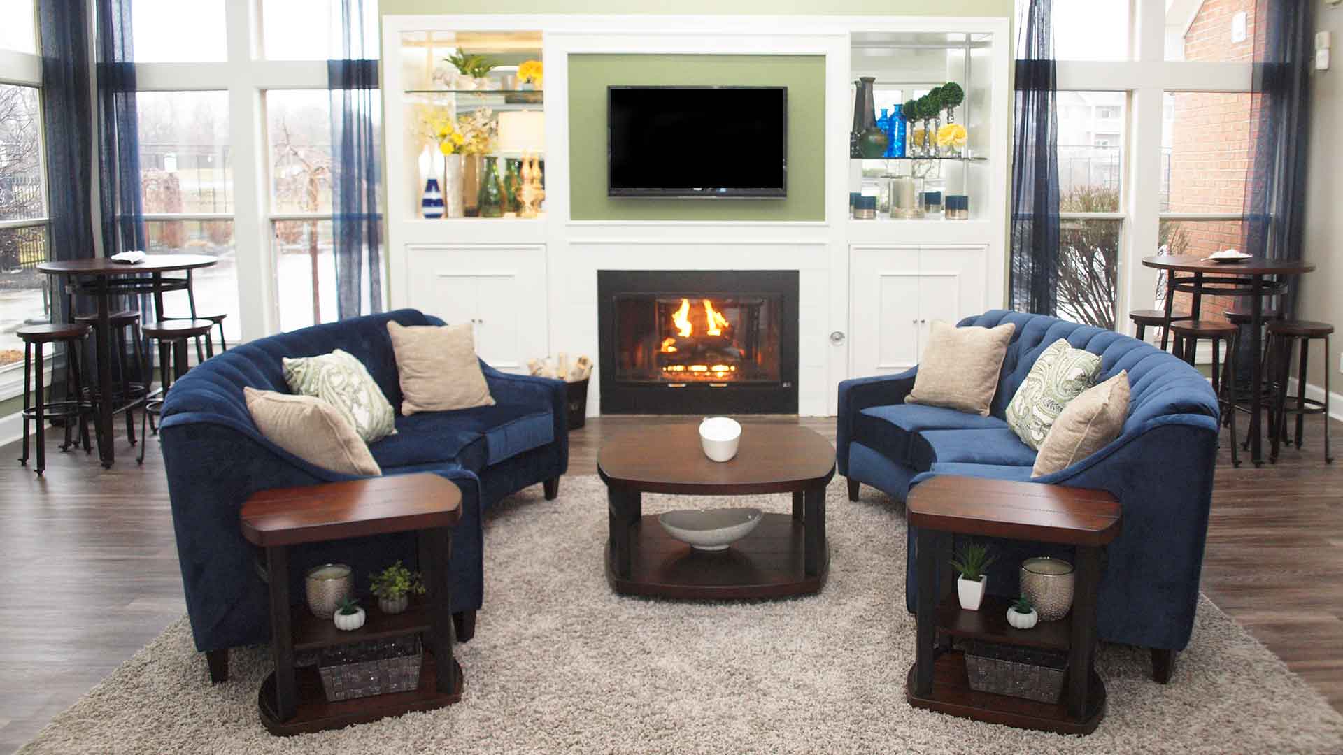 Decorated resident clubhouse with a TV and fireplace at Waterford Place.