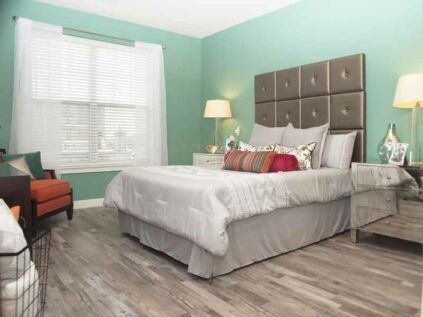 Spacious bedroom with wood grain flooring at Allure.