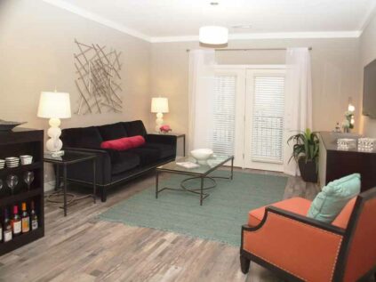 Decorate living room with wood grain flooring and a patio door at Allure.