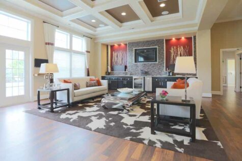 Furnished clubhouse at Brinley Place with tall ceilings and kitchen bar.