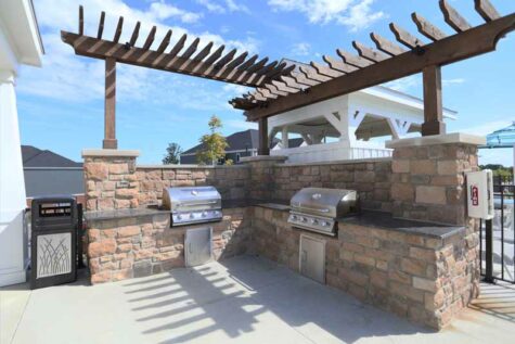 Community grills and cookout area by the pool at Greyson on 27.