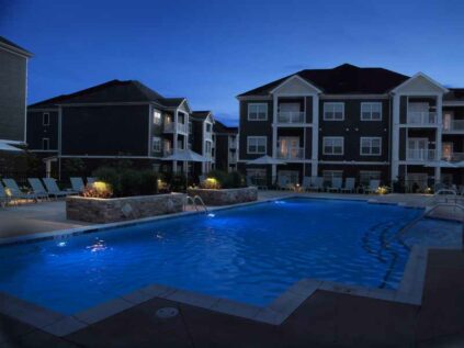 Pool with night lighting and lounge deck at Kendal on Taylorsville.