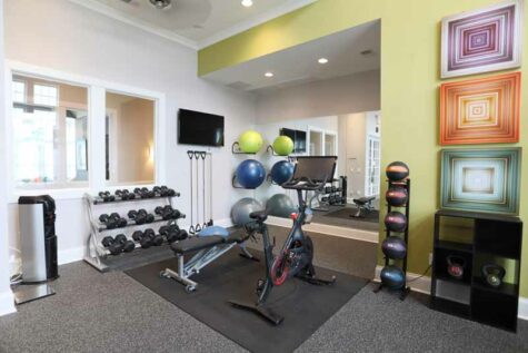 Fitness center with free weights and Peloton bike at Kendal on Taylorsville.