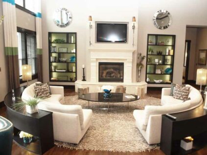 Furnished clubhouse space with a fireplace, sofas, and a mounted TV.
