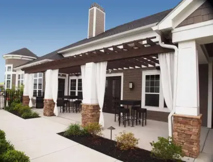 Clubhouse patio with seating and sun shades.