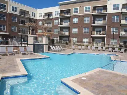 Luxury, saltwater pool with water features surrounded by lounge chairs.