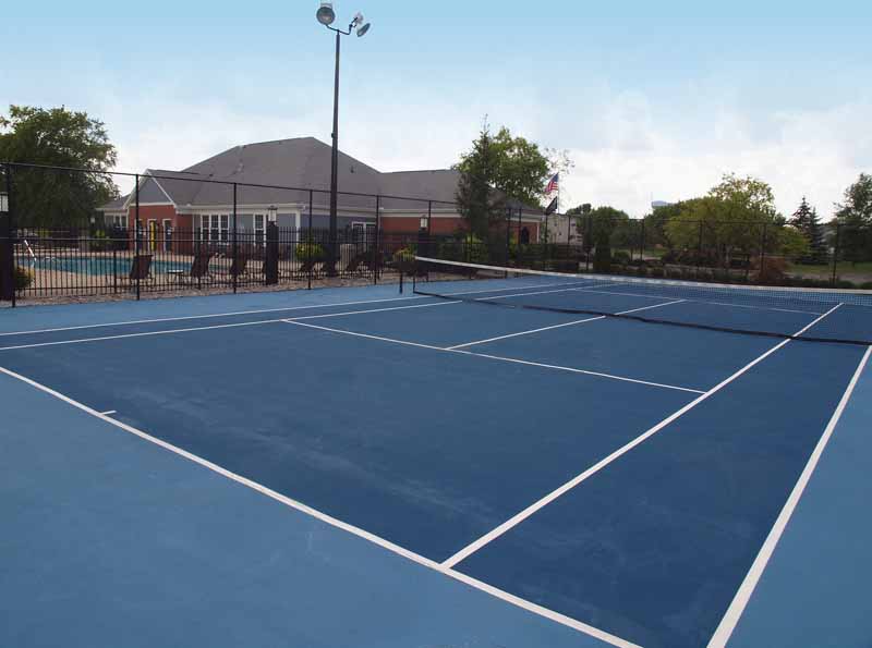 Tennis court next to gated community pool at Sterling Lakes.