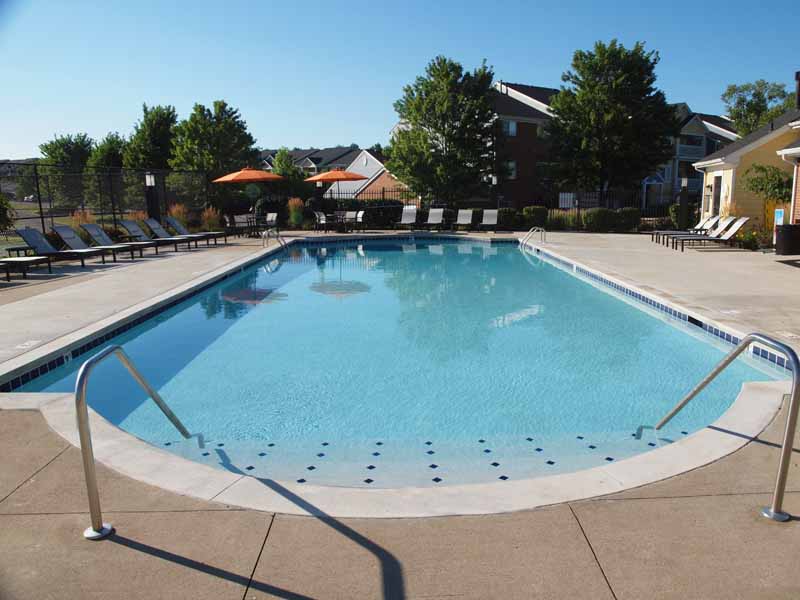 Outdoor pool and lounge deck with chairs at Waterford Place.