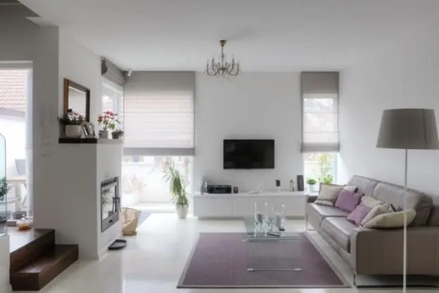 Airy sitting space with TV mounted adjacent to the fireplace
