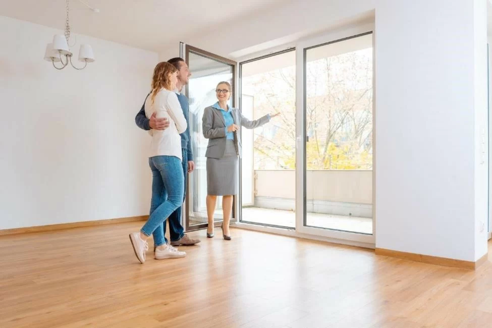 A realtor showing an apartment to a married couple