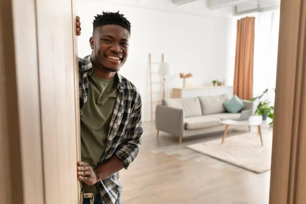 A man welcoming you into his new apartment