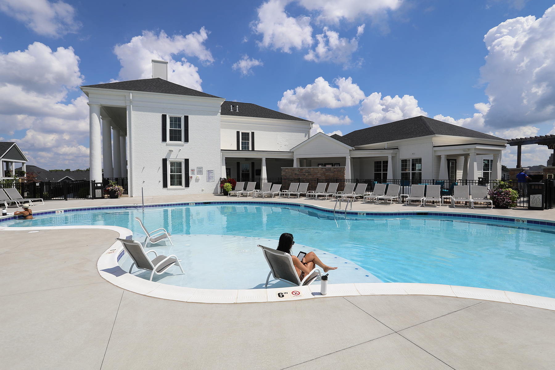 An on-site luxury pool sits aside a historic clubhouse.
