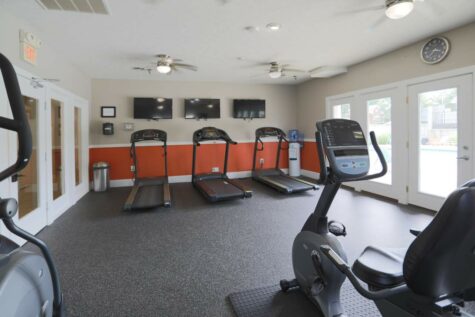 An on-site gym featuring several treadmills and ellipticals.