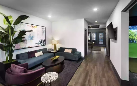 A luxury living room featuring dark, hardwood floors and wall mounted television.