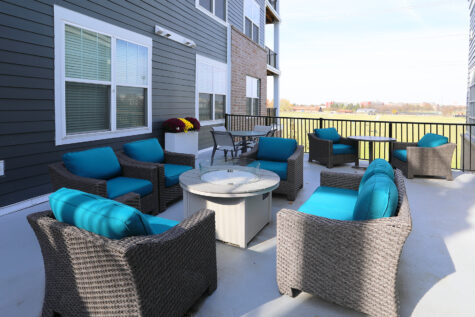 An outdoor lounge area, cozily nestled between two apartment buildings.
