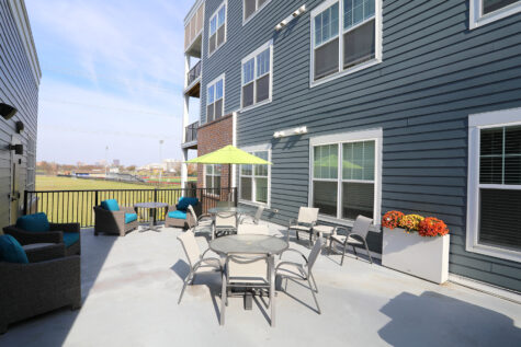 An outdoor lounge area, cozily nestled between two apartment buildings.