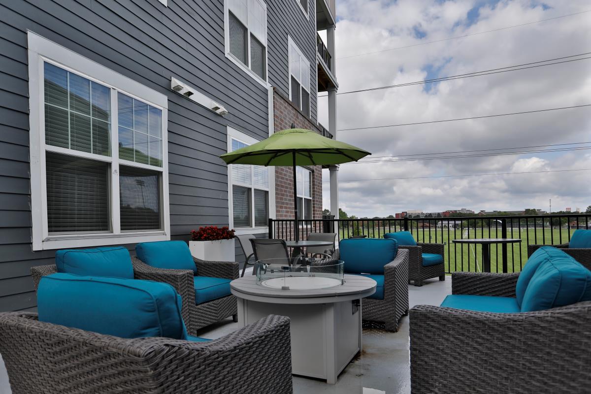 A view of the landscaping outside from the patio of an Element Oakwood apartment home.