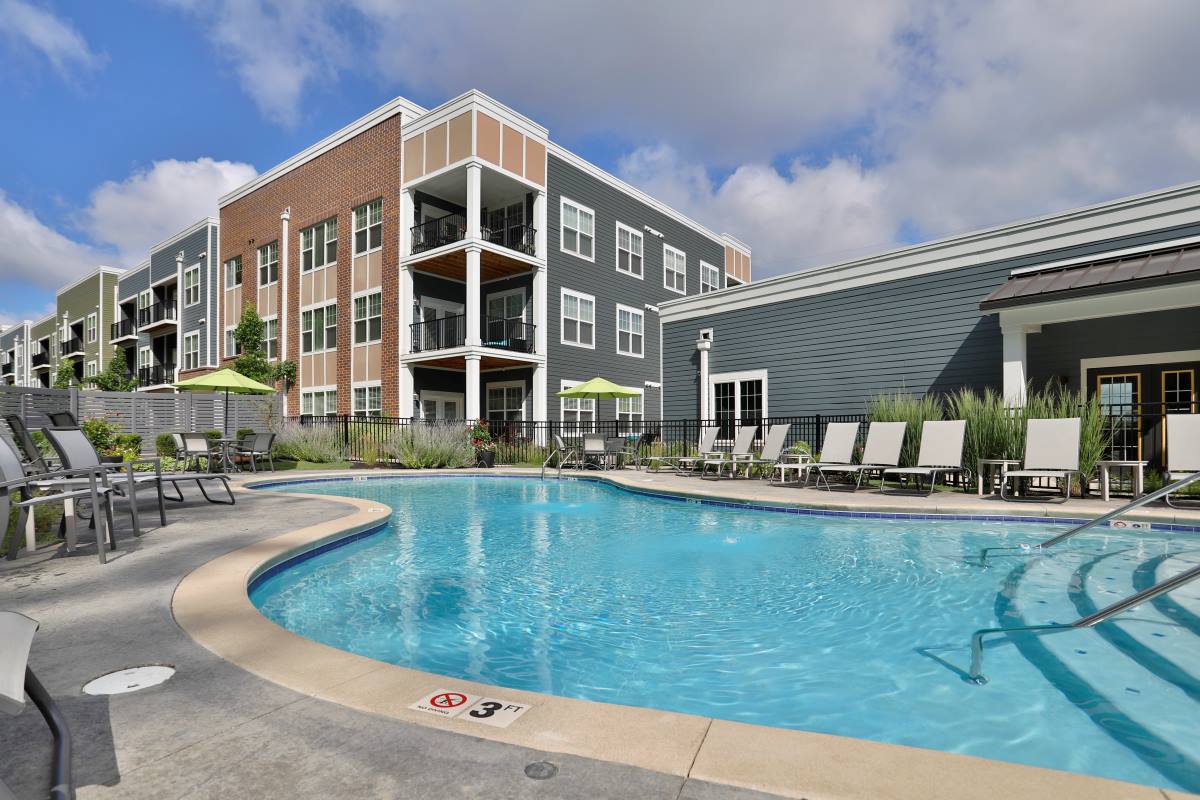 The Element Oakwood outdoor pool deck and apartment home facades.