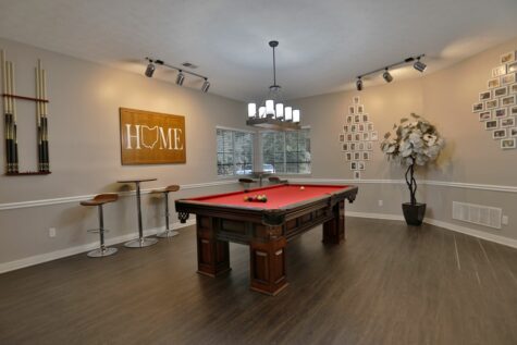 Fox Chase North's game room, featuring a red velvet billiards table central to a decorated room.