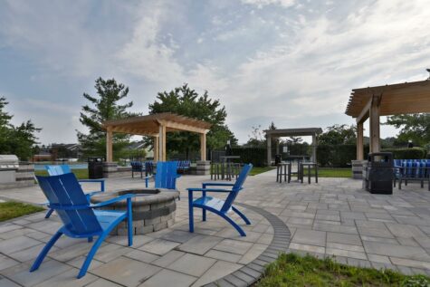 The Reserve at Miller Farm's outdoor social deck, featuring communal seating and paved walkways.