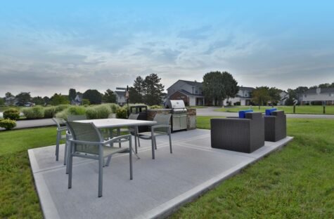 The outdoor seating area at the Reserve at Miller Farm community, featuring a grill.