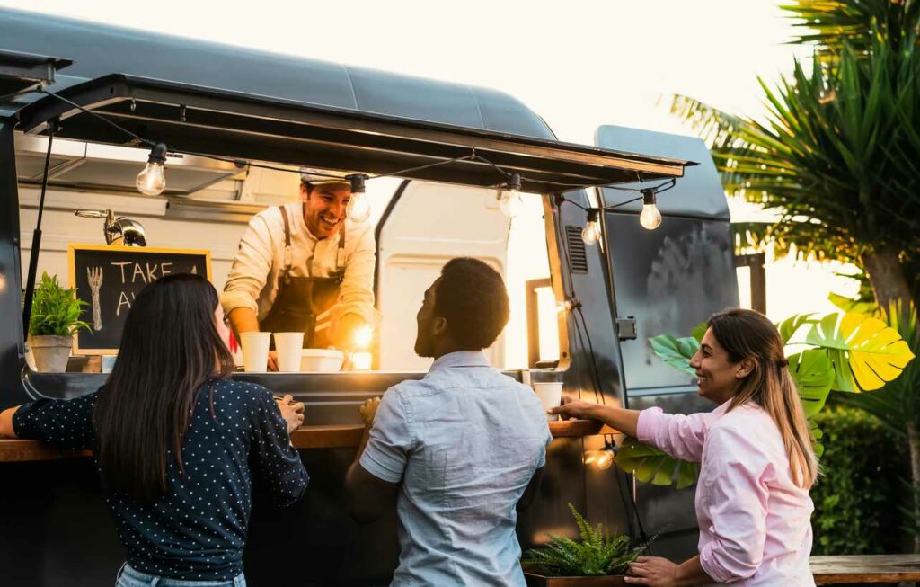 A group of friends getting food at a food truck.