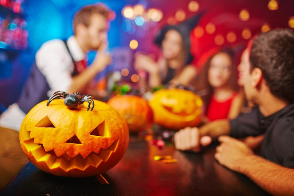 A group of friends celebrating Halloween in their apartment. 