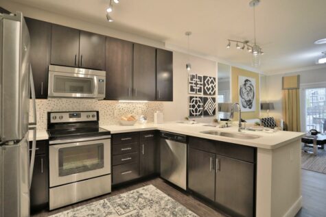 Kitchen with stainless steel appliances and dark cabinets
