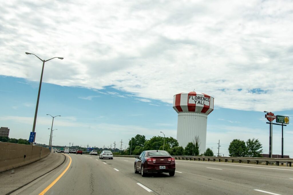 Cars traveling south on I-71 past Florence, Kentucky’s iconic water tower landmark.