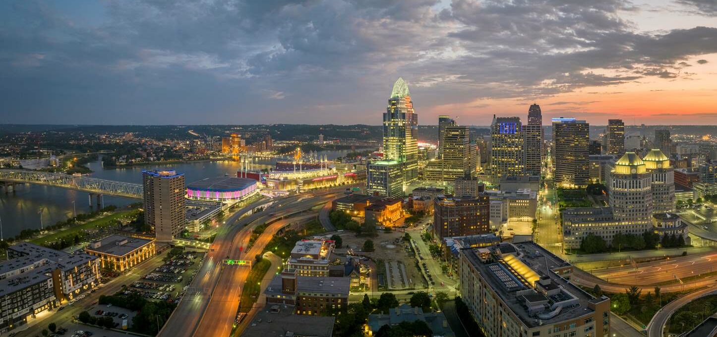 The Cincinnati, OH, city skyline and urban landscape lit up at night.