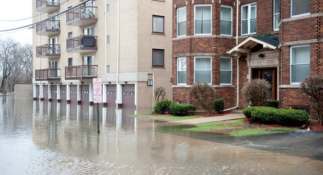 A view of floodwaters rising outside of apartment buildings.