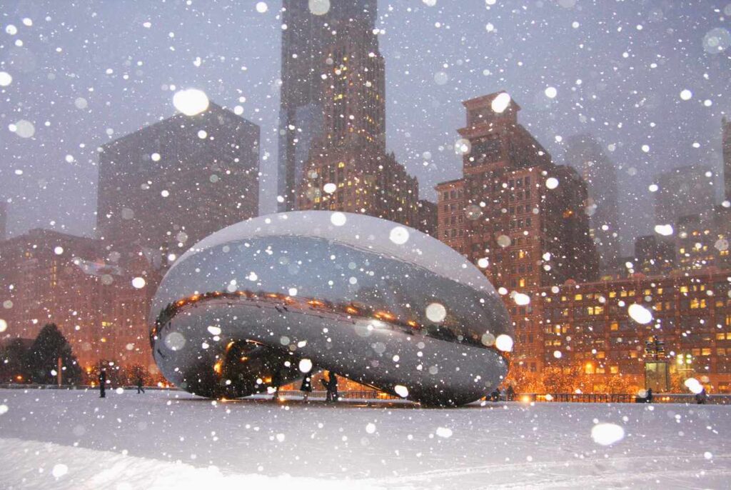 Cloud Gate, also known as The Bean, in Millennium Park on a snowy evening in Chicago, IL.