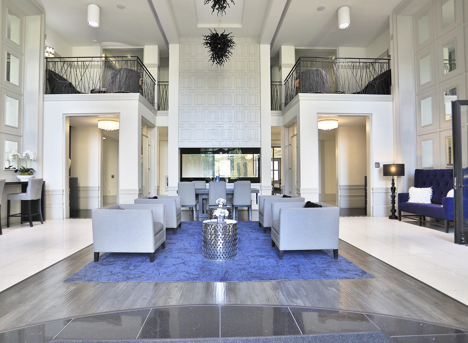 24-hour clubhouse at 49Hundred Apartments in Blue Ash, Ohio, featuring a balcony with seating area and direct access to the resident lounge, offering a stylish and inviting space for relaxation and socializing.