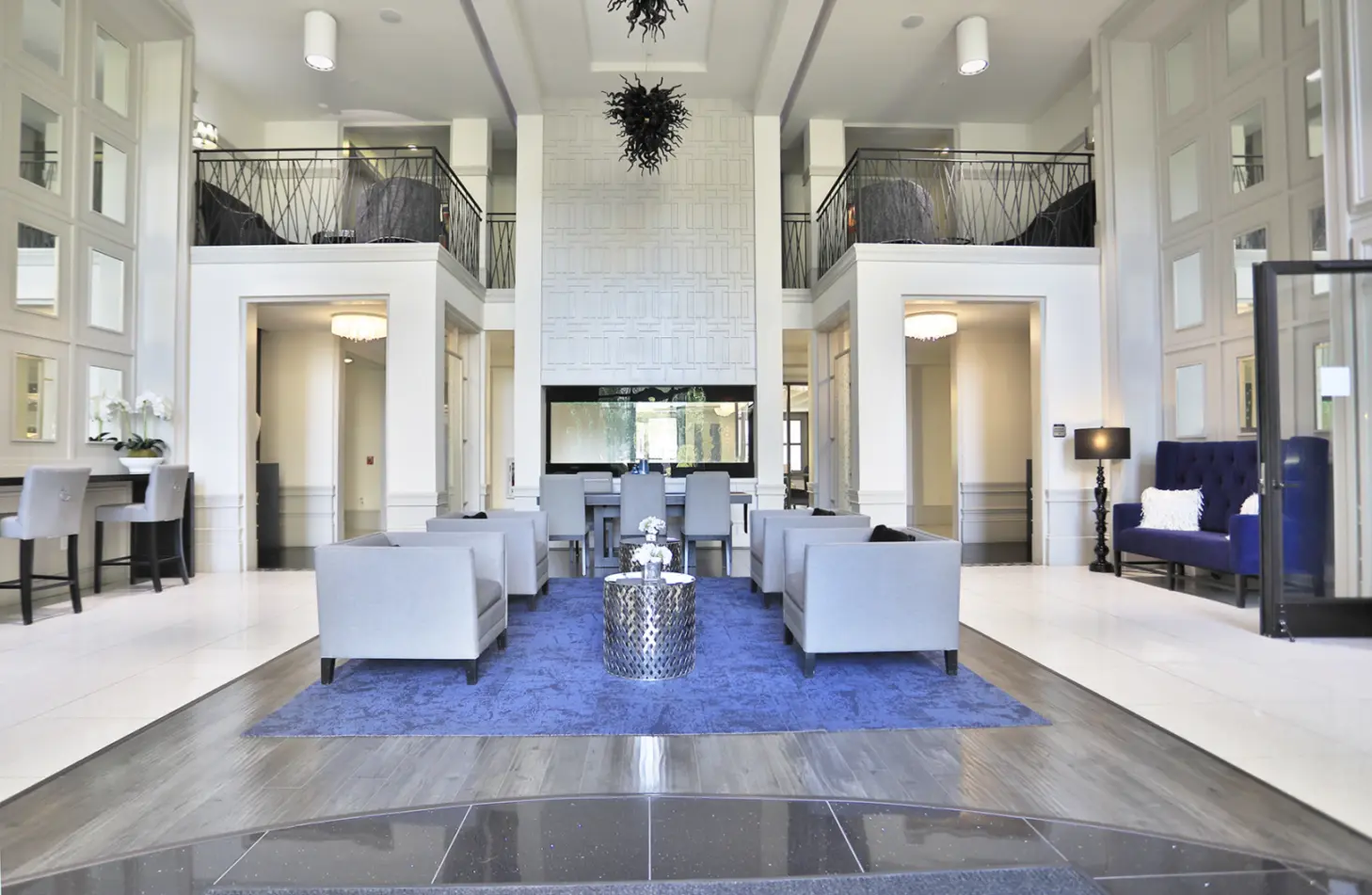 24-hour clubhouse at 49Hundred Apartments in Blue Ash, Ohio, featuring a balcony with seating area and direct access to the resident lounge, offering a stylish and inviting space for relaxation and socializing.