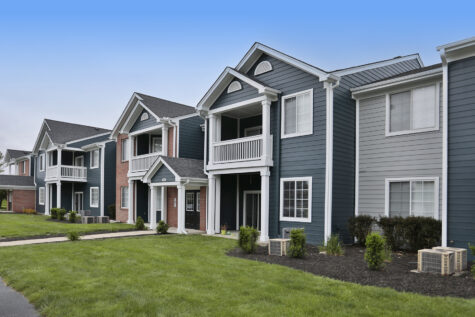 Exterior of a two-bedroom building at Emerald Lakes Apartments in Greenwood, Indiana, featuring newly updated exterior paint, modern design elements, and well-kept landscaping.